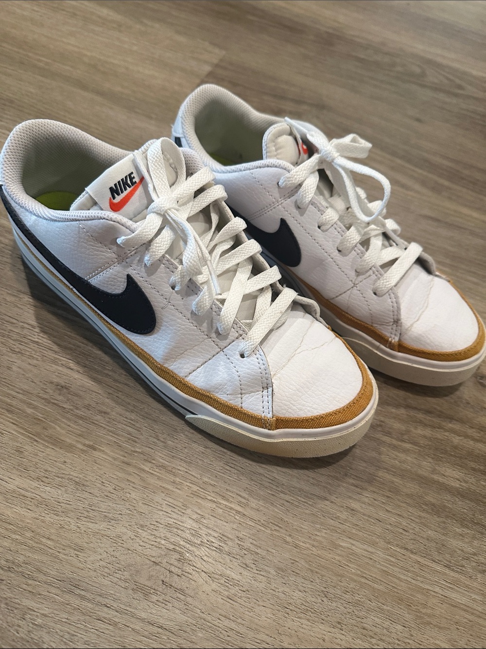 Nike White Low-Top Sneakers with Black Swoosh and Tan Trim court legacy
